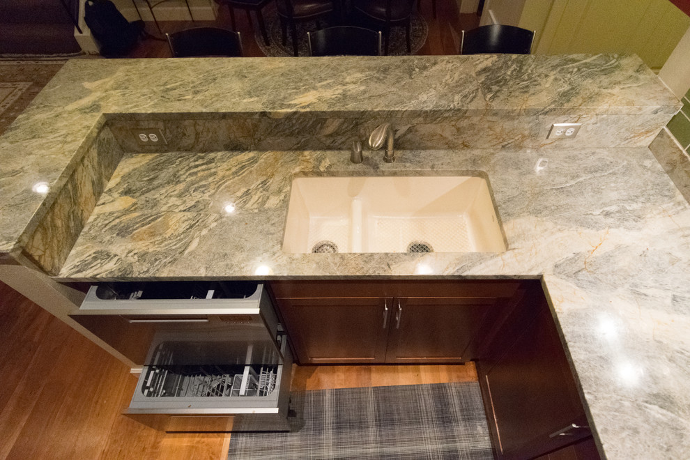 Inspiration for a transitional home design remodel with an undermount sink, granite countertops, green backsplash, stone slab backsplash and stainless steel appliances