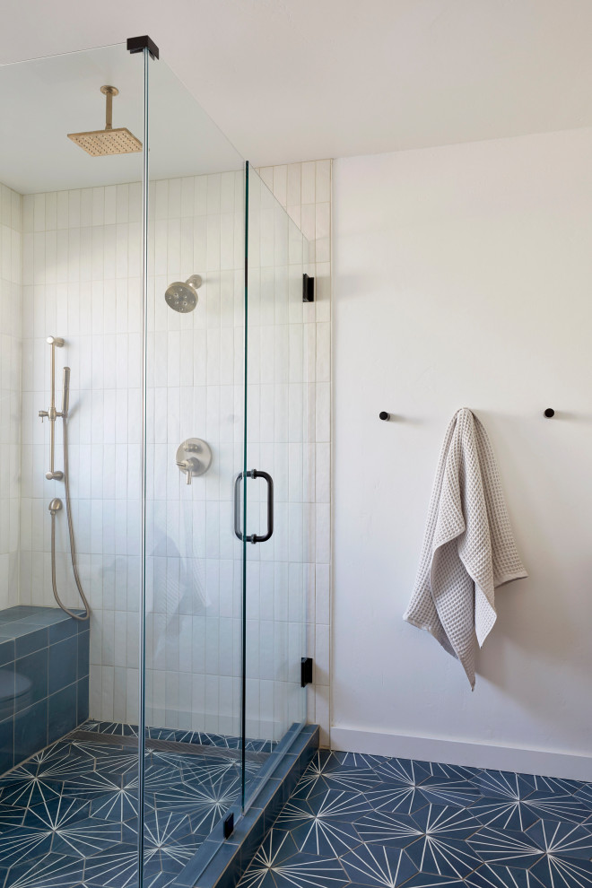 Inspiration for a medium sized midcentury ensuite bathroom in San Francisco with flat-panel cabinets, brown cabinets, a corner shower, white tiles, ceramic tiles, white walls, cement flooring, a submerged sink, engineered stone worktops, blue floors, a hinged door, white worktops, a shower bench, double sinks and a freestanding vanity unit.