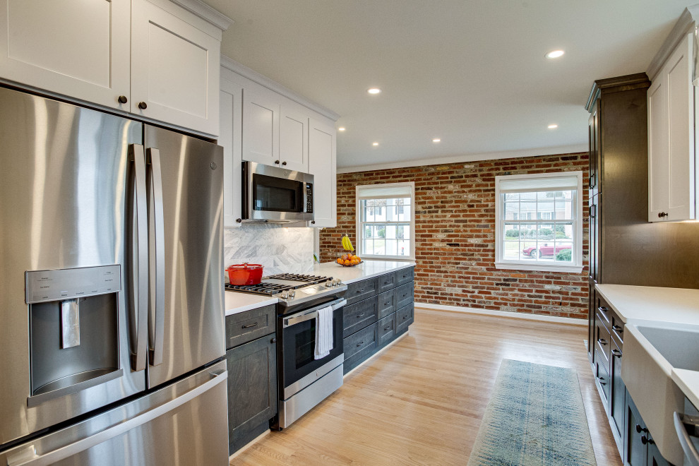 Inspiration for a small transitional single-wall kitchen remodel in DC Metro with a farmhouse sink, quartz countertops, stainless steel appliances and a peninsula