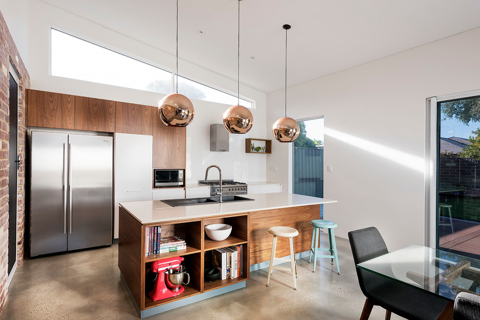 Photo of a small contemporary galley eat-in kitchen in Perth with an undermount sink, open cabinets, medium wood cabinets, quartz benchtops, white splashback, glass sheet splashback, stainless steel appliances, with island and concrete floors.