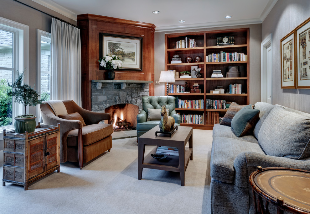 This is an example of a mid-sized transitional study room in Dallas with grey walls, carpet, a corner fireplace, a stone fireplace surround, a built-in desk and grey floor.