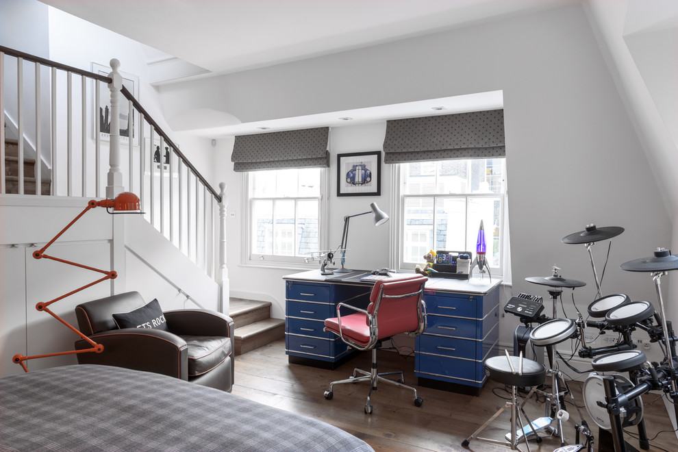 This is an example of a mid-sized transitional kids' room in London with white walls, medium hardwood floors and brown floor.