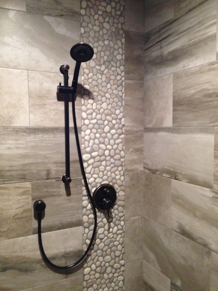This is an example of a large arts and crafts master wet room bathroom in Santa Barbara with recessed-panel cabinets, brown cabinets, a one-piece toilet, gray tile, ceramic tile, beige walls, slate floors, an undermount sink, engineered quartz benchtops, black floor, a hinged shower door and multi-coloured benchtops.