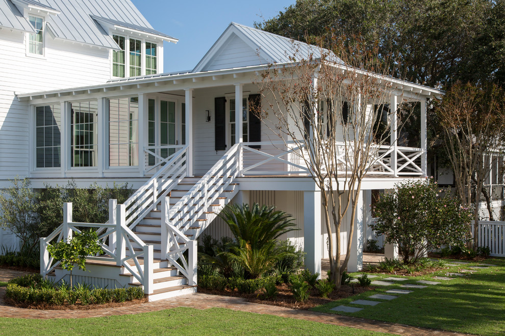Beach style front yard verandah in Charleston with brick pavers and a roof extension.
