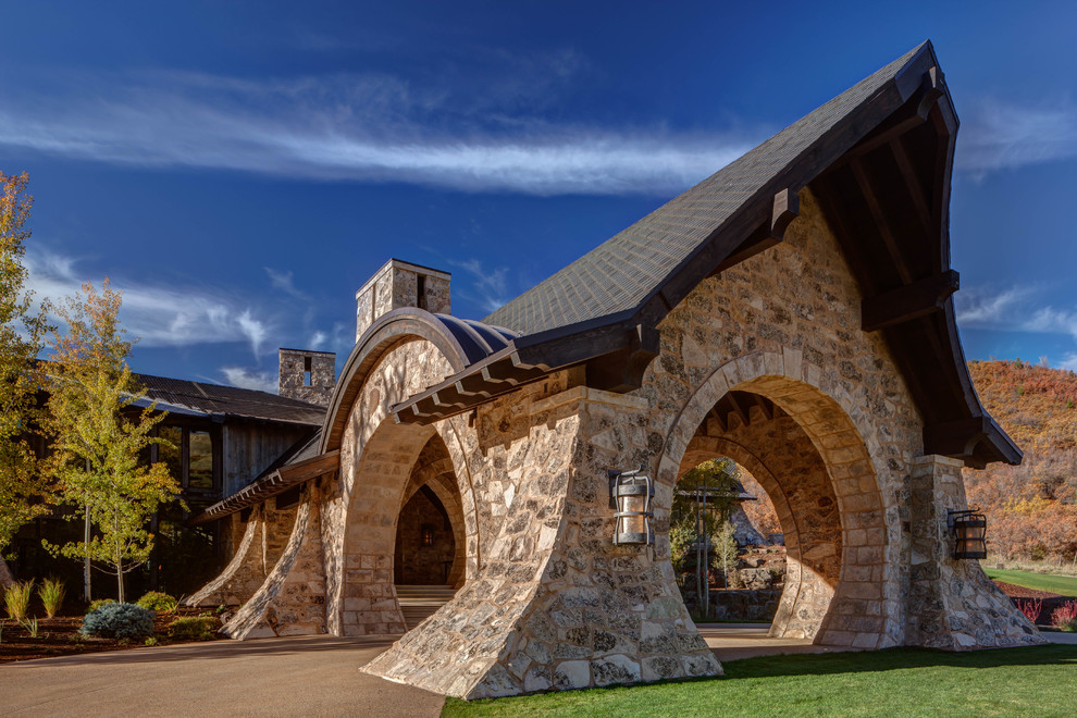 Inspiration for a large transitional two-storey grey exterior in Salt Lake City with stone veneer.
