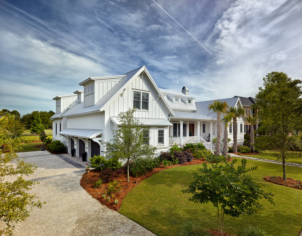 This is an example of a beach style white exterior in Charleston.