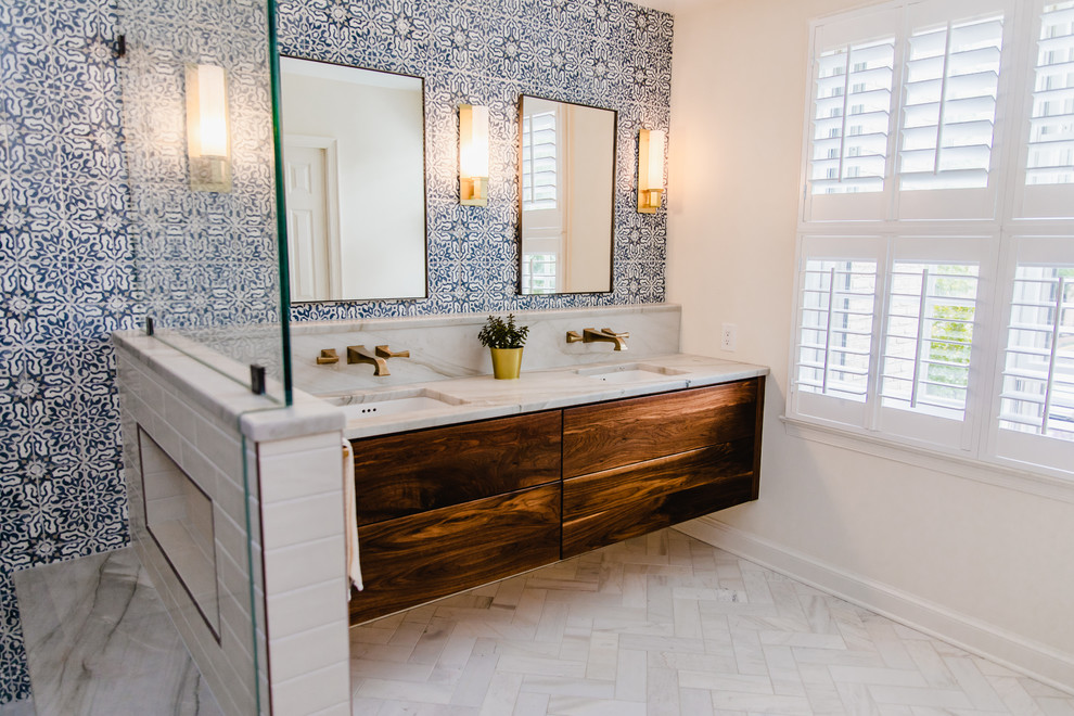 Inspiration for a mid-sized contemporary master bathroom in DC Metro with shaker cabinets, brown cabinets, marble benchtops, a double shower, a one-piece toilet, blue tile, subway tile, white walls, marble floors, an undermount sink, white floor, a hinged shower door and white benchtops.