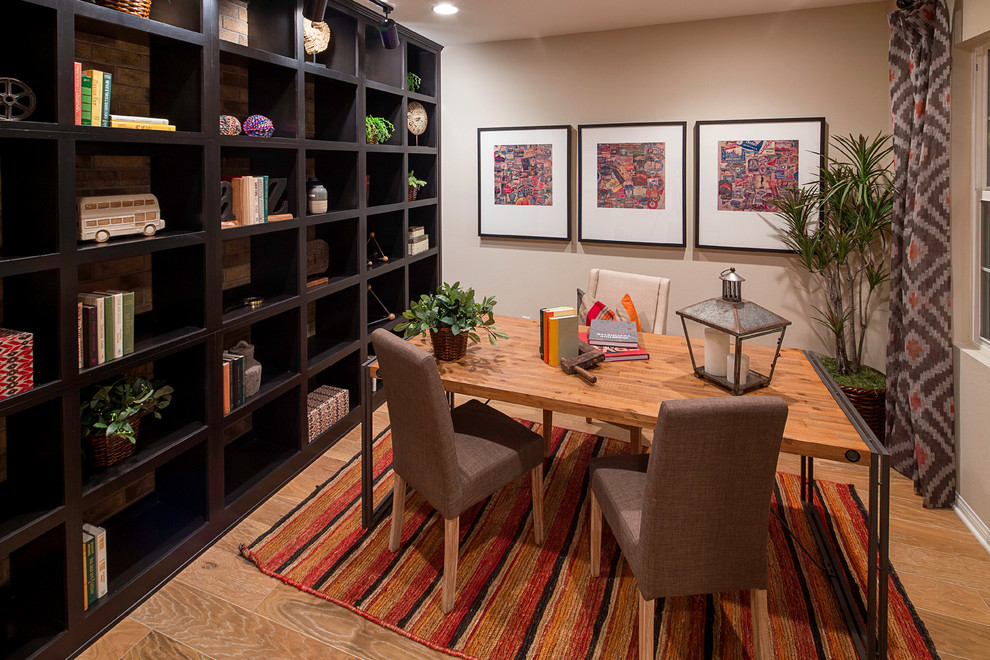 Inspiration for a contemporary study room in Los Angeles with grey walls, light hardwood floors and a freestanding desk.