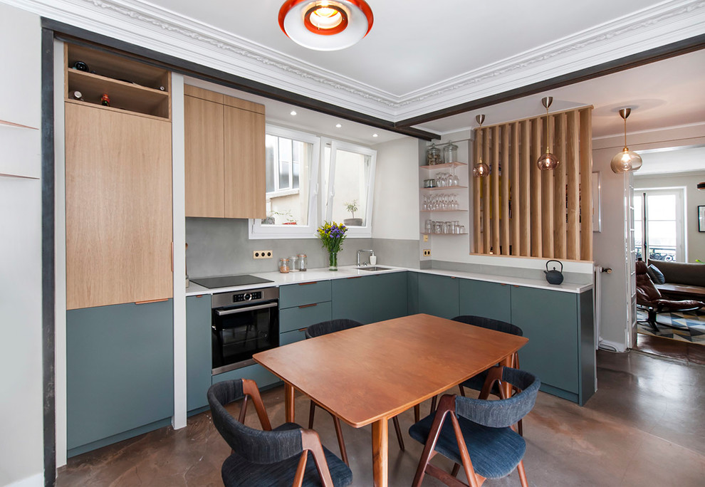 Large modern l-shaped eat-in kitchen in Paris with a single-bowl sink, beaded inset cabinets, green cabinets, marble benchtops, beige splashback, panelled appliances, concrete floors, no island, brown floor and beige benchtop.