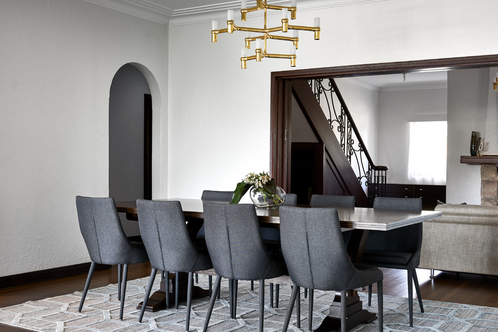 Photo of a large contemporary open plan dining in Sydney with white walls, dark hardwood floors and brown floor.