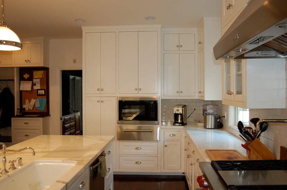 Design ideas for a traditional kitchen in Burlington with shaker cabinets, white cabinets, marble benchtops, stainless steel appliances and dark hardwood floors.