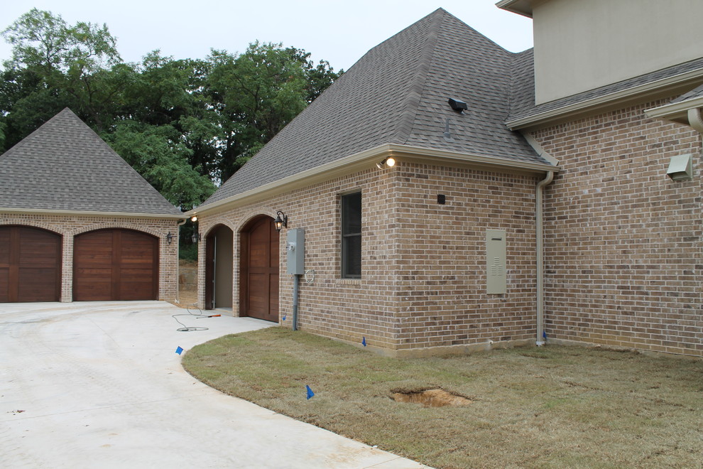 Inspiration for a large timeless attached three-car garage remodel in Dallas