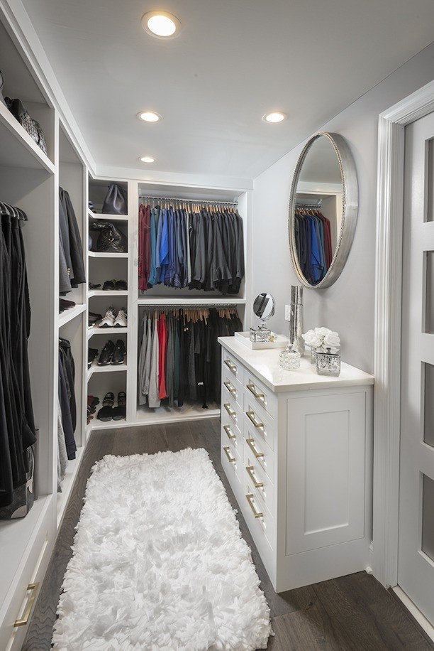 Inspiration for a small transitional gender-neutral walk-in wardrobe in Philadelphia with recessed-panel cabinets, white cabinets, dark hardwood floors and brown floor.