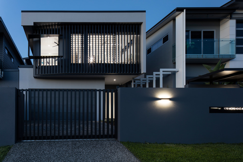 This is an example of a mid-sized contemporary two-storey grey house exterior in Brisbane with a flat roof and a metal roof.