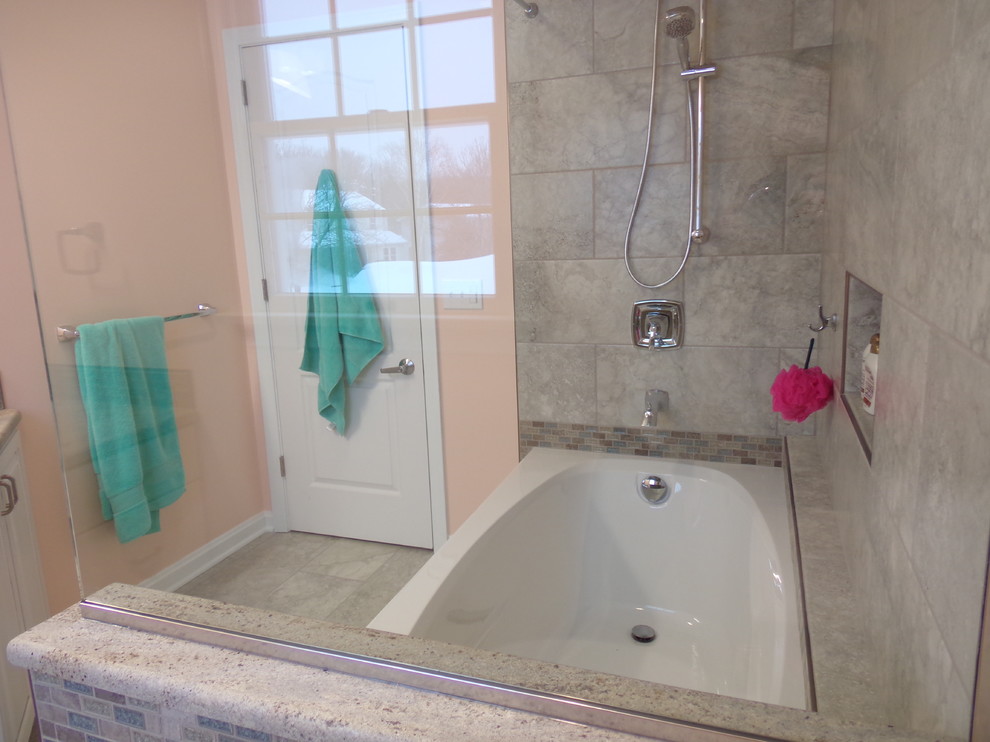Example of a mid-sized transitional kids' gray tile and porcelain tile porcelain tile alcove bathtub design with an undermount sink, raised-panel cabinets, white cabinets, granite countertops and orange walls