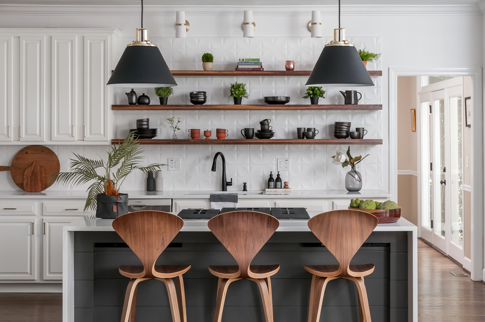 Design ideas for a mid-sized modern l-shaped eat-in kitchen in Atlanta with open cabinets, dark wood cabinets, quartzite benchtops, white splashback, with island, white benchtop, a drop-in sink, ceramic splashback, stainless steel appliances, dark hardwood floors and brown floor.