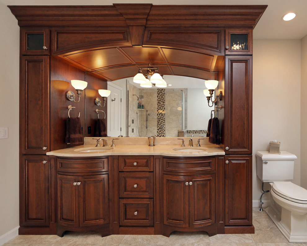 Design ideas for a large traditional master bathroom in Boston with furniture-like cabinets, dark wood cabinets, an undermount sink, granite benchtops, a freestanding tub, a corner shower, a one-piece toilet, beige tile, ceramic tile, beige walls and ceramic floors.