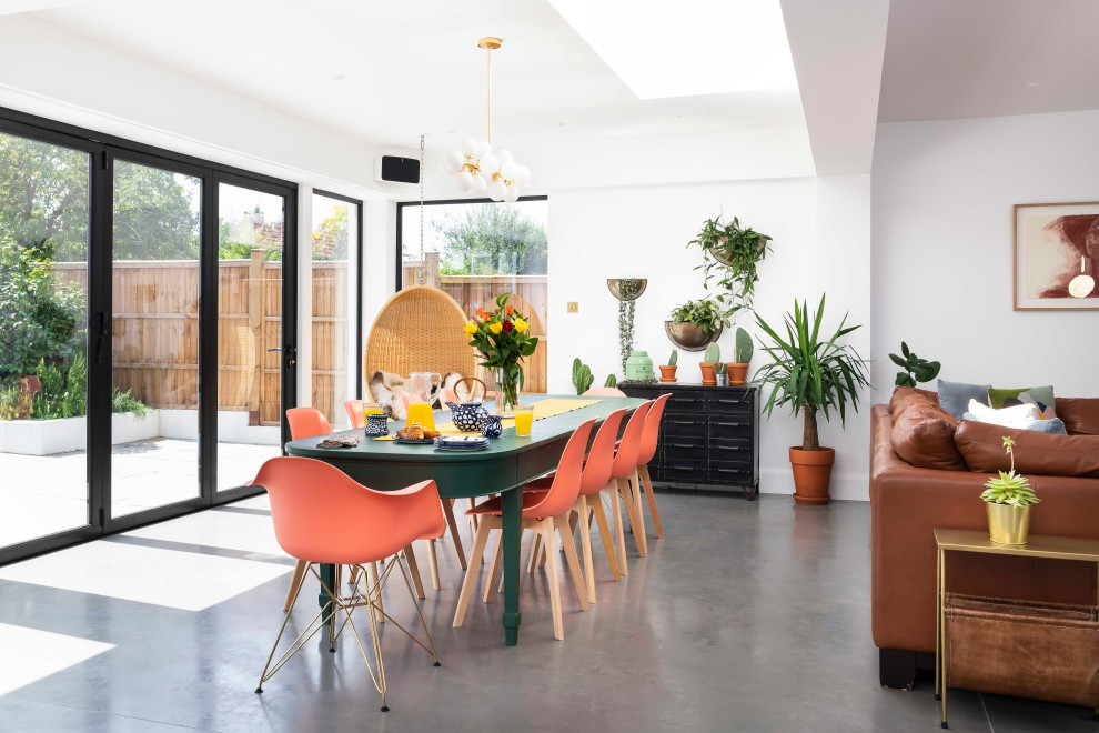 Inspiration for a contemporary open plan dining in London with white walls, concrete floors and grey floor.