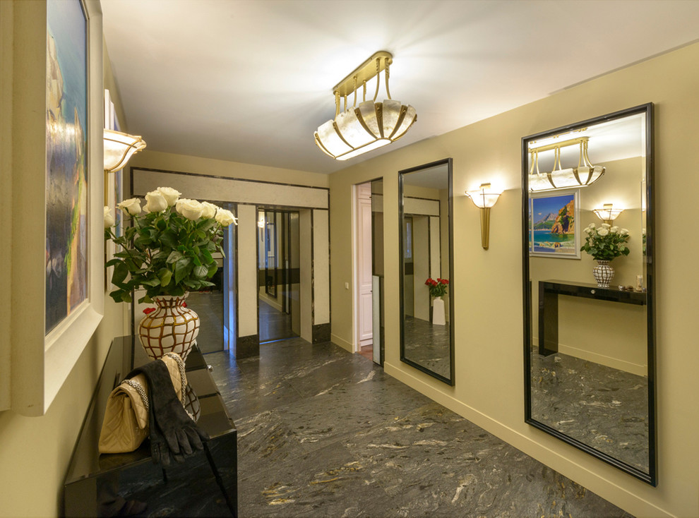 This is an example of a mid-sized contemporary entry hall in Saint Petersburg with beige walls and marble floors.