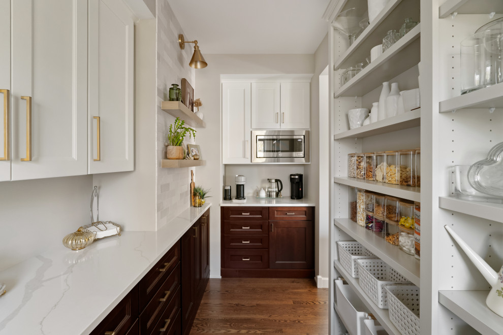 Transitional u-shaped medium tone wood floor and brown floor kitchen photo in Minneapolis with shaker cabinets, dark wood cabinets, stainless steel appliances and white countertops