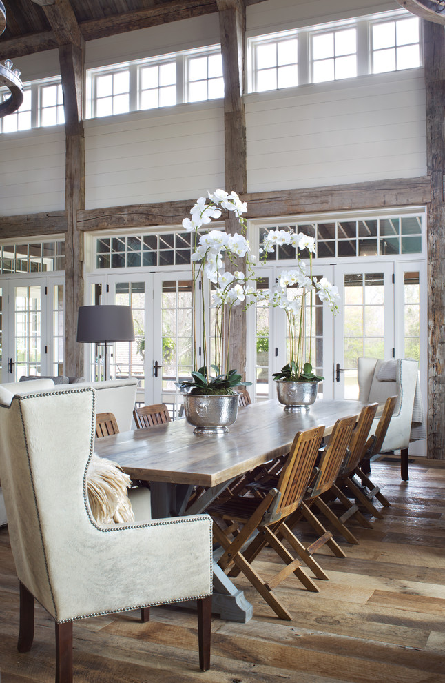 Photo of a large country open plan dining in Denver with white walls, medium hardwood floors, brown floor and no fireplace.