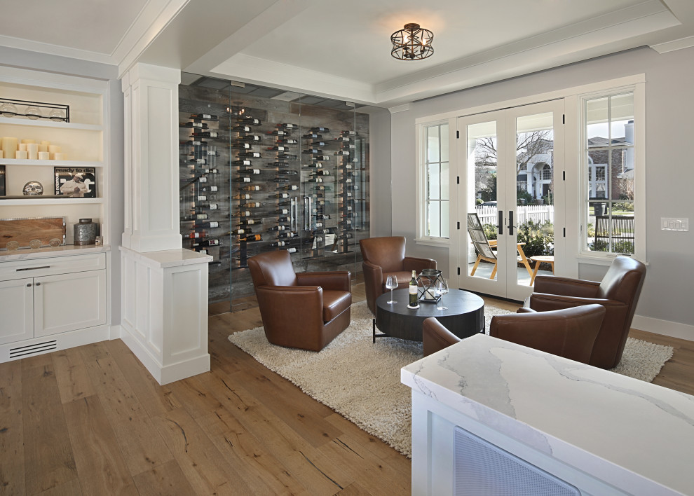 Mid-sized transitional light wood floor wine cellar photo in Orange County with display racks