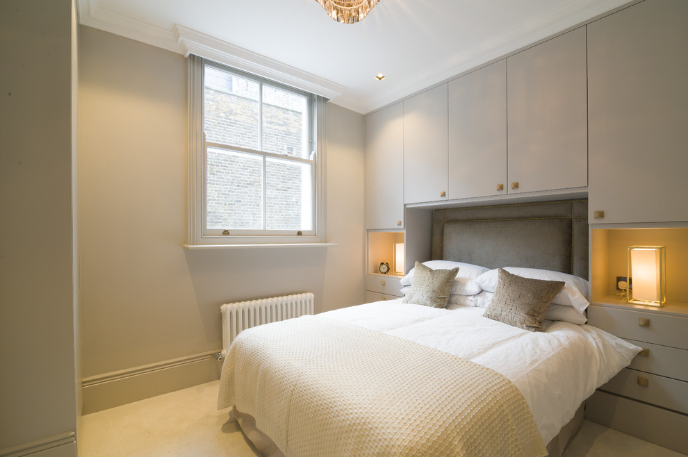 Photo of a mid-sized contemporary guest bedroom in London with beige walls and carpet.