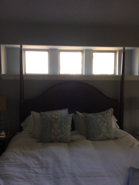 Bedroom with high clearance windows