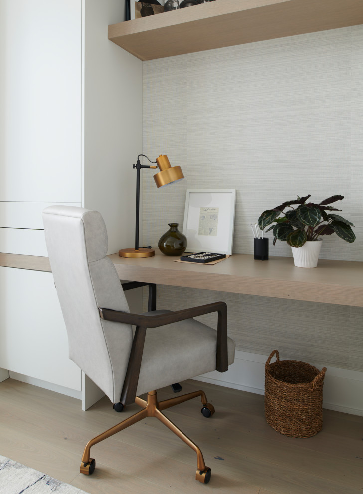 Imagen de despacho contemporáneo de tamaño medio con paredes beige, suelo de madera clara, escritorio empotrado, suelo marrón y papel pintado