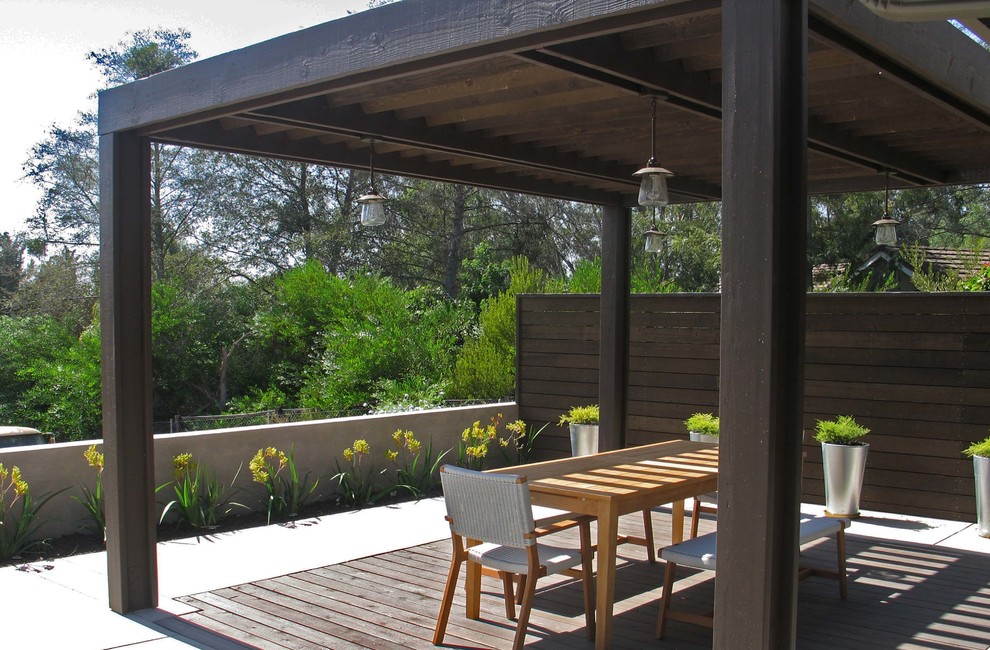This is an example of a large contemporary backyard deck in San Diego with a pergola.