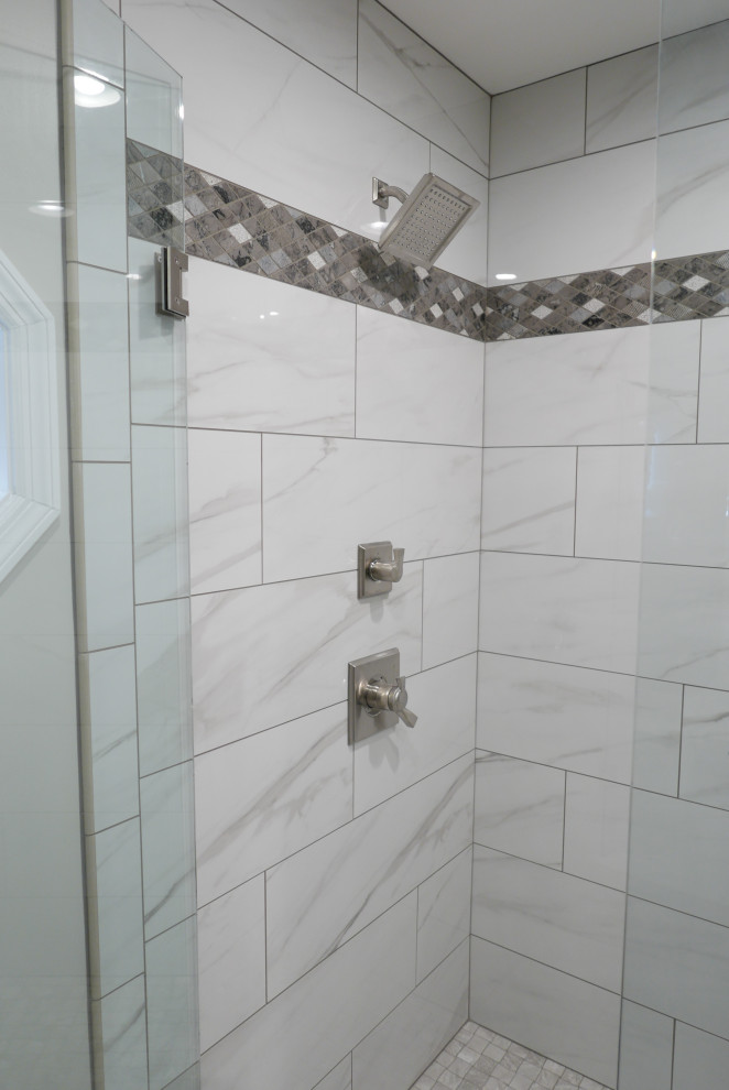 This is an example of a mid-sized transitional master bathroom in Other with shaker cabinets, grey cabinets, an alcove shower, a two-piece toilet, white tile, porcelain tile, grey walls, porcelain floors, an undermount sink, engineered quartz benchtops, white floor, a hinged shower door and multi-coloured benchtops.