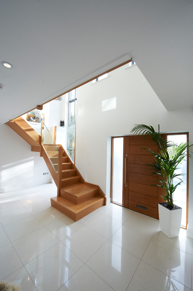 Contemporary wood l-shaped staircase in Other with wood risers.