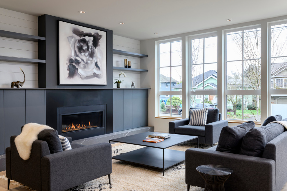 This is an example of a mid-sized contemporary formal open concept living room in Seattle with white walls, light hardwood floors, a ribbon fireplace, a metal fireplace surround, no tv and planked wall panelling.