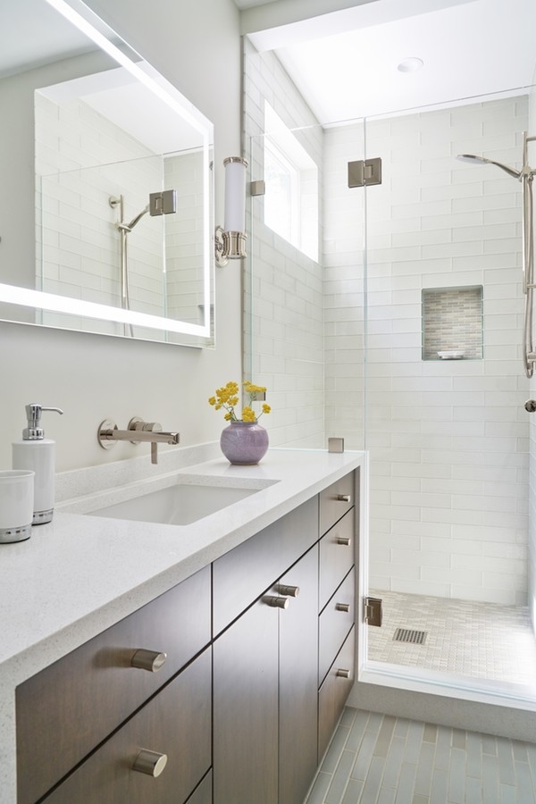Inspiration for a contemporary bathroom in Los Angeles with flat-panel cabinets, an alcove shower, glass tile, porcelain floors, an undermount sink, engineered quartz benchtops, a hinged shower door and white benchtops.