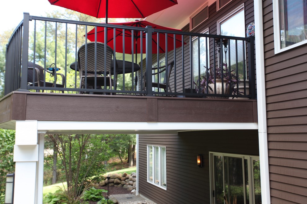 Example of a mid-sized transitional backyard deck design in Grand Rapids with no cover