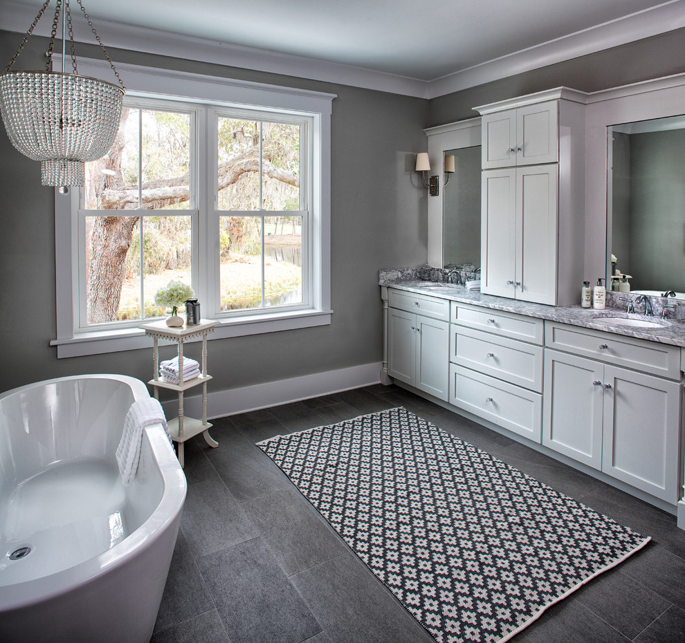 Inspiration for a mid-sized country master bathroom in Charleston with shaker cabinets, white cabinets, a freestanding tub, an open shower, a two-piece toilet, gray tile, porcelain tile, grey walls, porcelain floors, an undermount sink and marble benchtops.