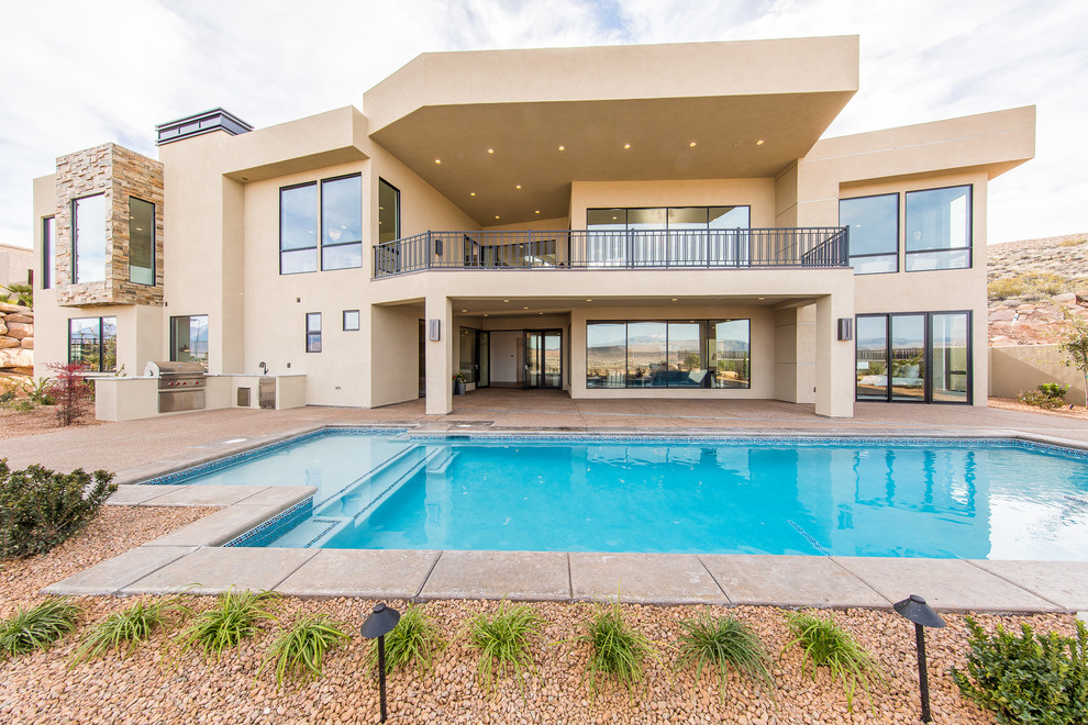 Pool fountain - large transitional backyard concrete paver and custom-shaped natural pool fountain idea in Las Vegas