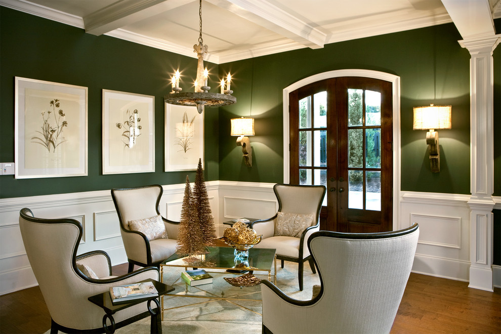 Example of a classic formal and open concept medium tone wood floor living room design in Charlotte with green walls
