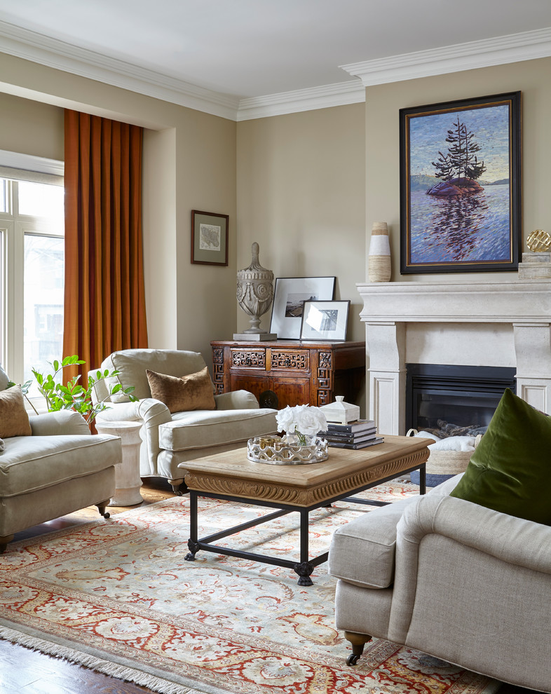 Design ideas for a mid-sized traditional formal living room in Toronto with beige walls, a standard fireplace and no tv.