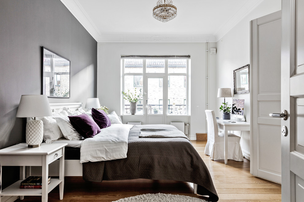 Mid-sized scandinavian bedroom in Gothenburg with white walls, light hardwood floors and beige floor.