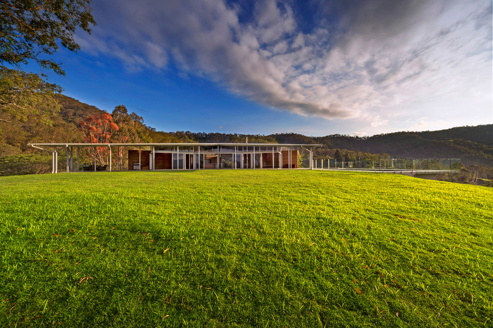 Design ideas for a large contemporary glass grey exterior in Brisbane.