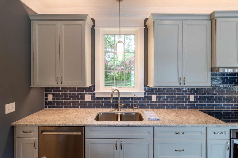 Medium sized traditional kitchen in Baltimore with a built-in sink, blue splashback, metro tiled splashback, stainless steel appliances and multicoloured worktops.