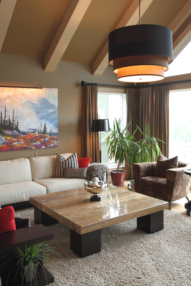 Photo of an expansive transitional formal open concept living room in Calgary with beige walls, light hardwood floors, a standard fireplace, a brick fireplace surround and no tv.