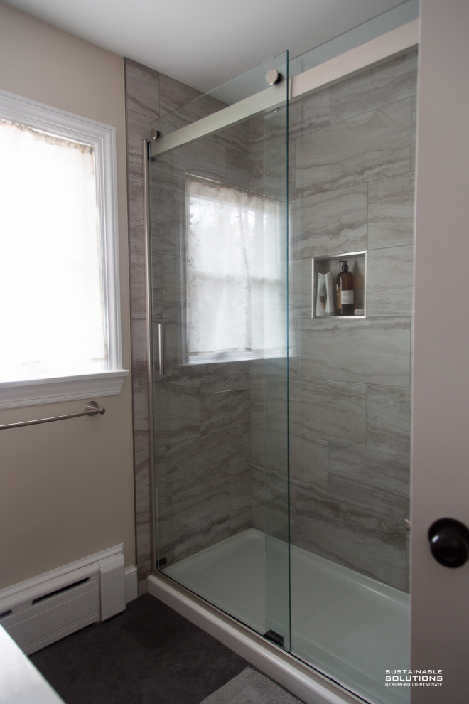 Example of a transitional single-sink bathroom design with light wood cabinets