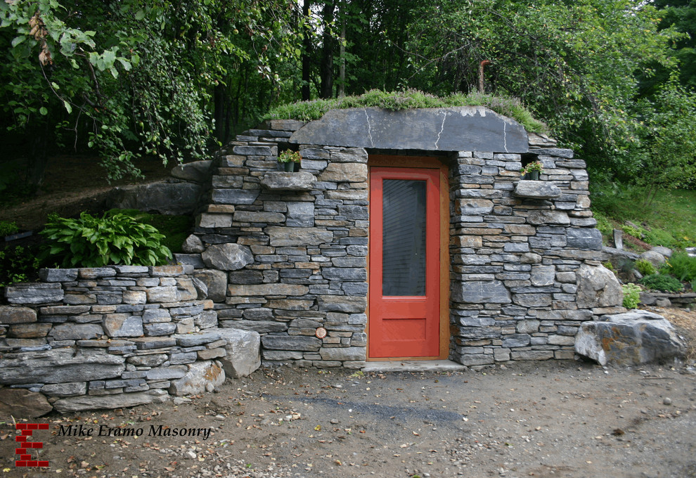This is an example of a mid-sized rustic shade hillside landscaping in Burlington.