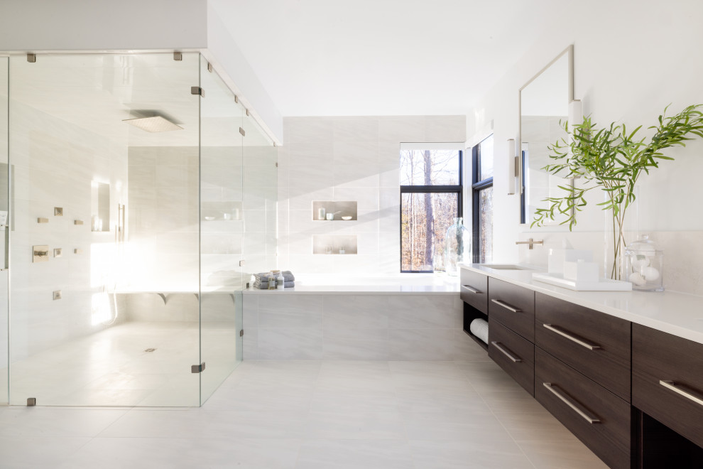 Walk-in shower - huge modern master white tile and porcelain tile porcelain tile, white floor and double-sink walk-in shower idea with flat-panel cabinets, dark wood cabinets, an undermount tub, a wall-mount toilet, white walls, an undermount sink, quartz countertops, a hinged shower door, white countertops and a floating vanity