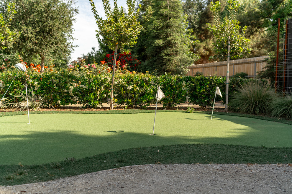 Design ideas for a traditional backyard full sun garden in Other with with outdoor playset and gravel.