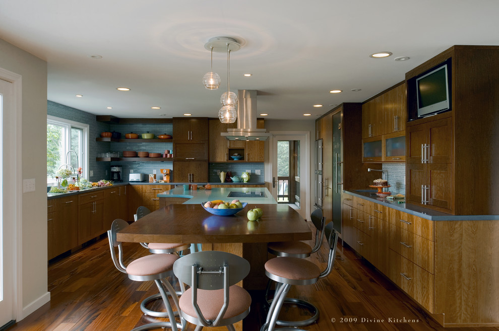Inspiration for an expansive contemporary u-shaped eat-in kitchen in Boston with an undermount sink, flat-panel cabinets, dark wood cabinets, concrete benchtops, blue splashback, glass tile splashback, stainless steel appliances, dark hardwood floors and with island.