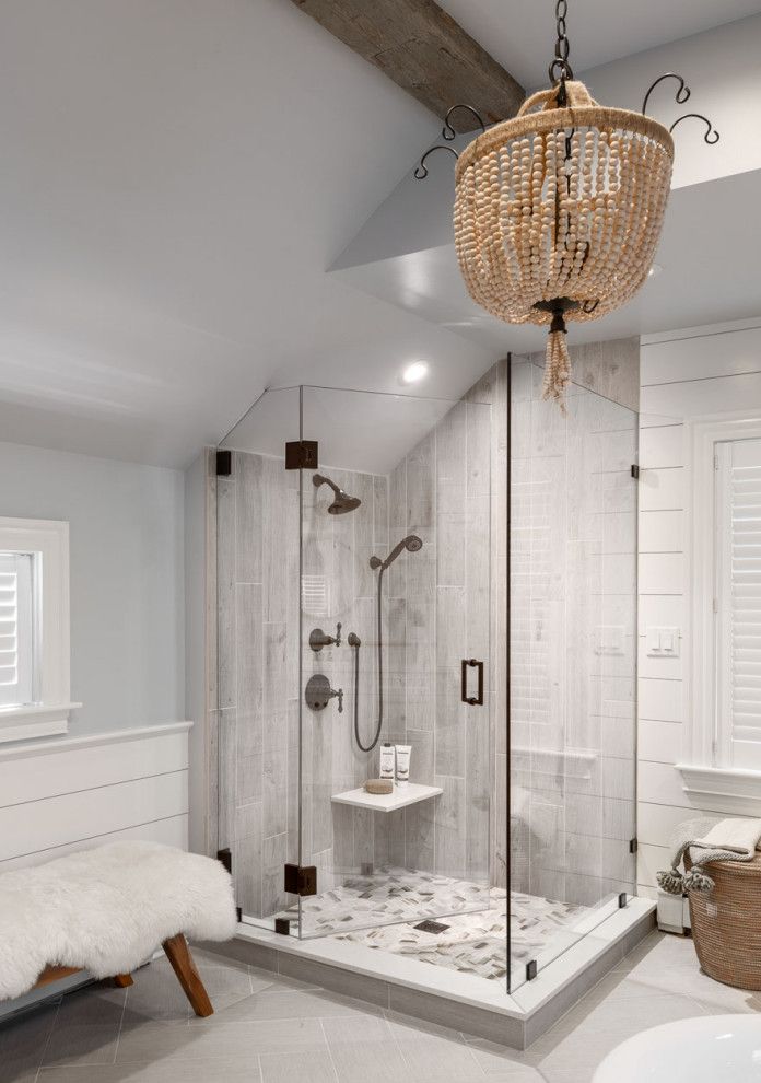 Design ideas for a large transitional master bathroom in Boston with recessed-panel cabinets, white cabinets, a freestanding tub, a corner shower, a two-piece toilet, gray tile, ceramic tile, grey walls, porcelain floors, an undermount sink, engineered quartz benchtops, grey floor, a hinged shower door, white benchtops, a double vanity, exposed beam and planked wall panelling.