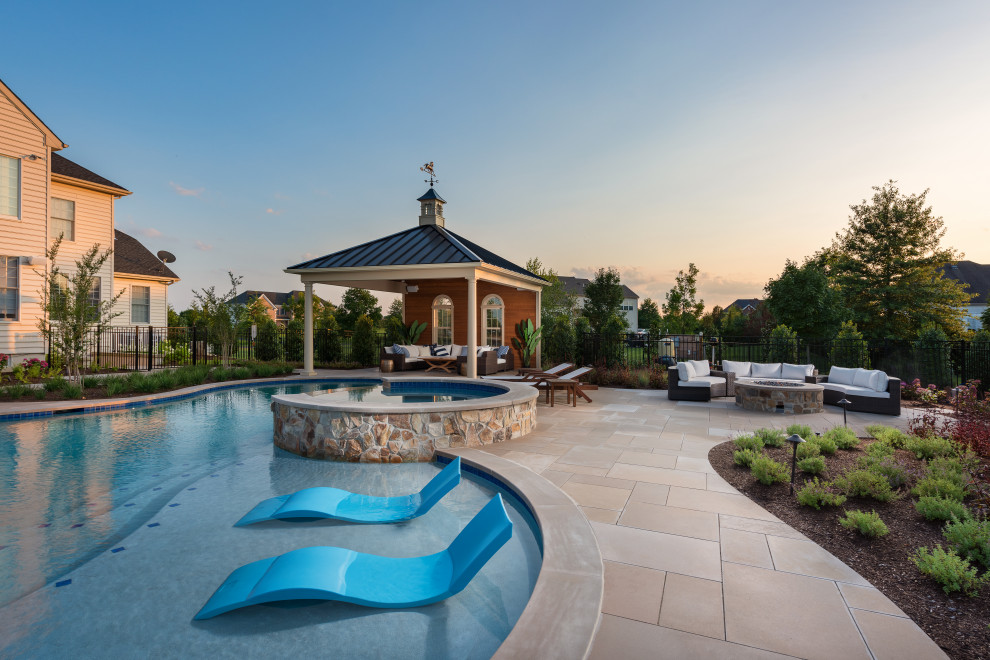 Inspiration for a large traditional back custom shaped natural swimming pool in New York with with pool landscaping and natural stone paving.